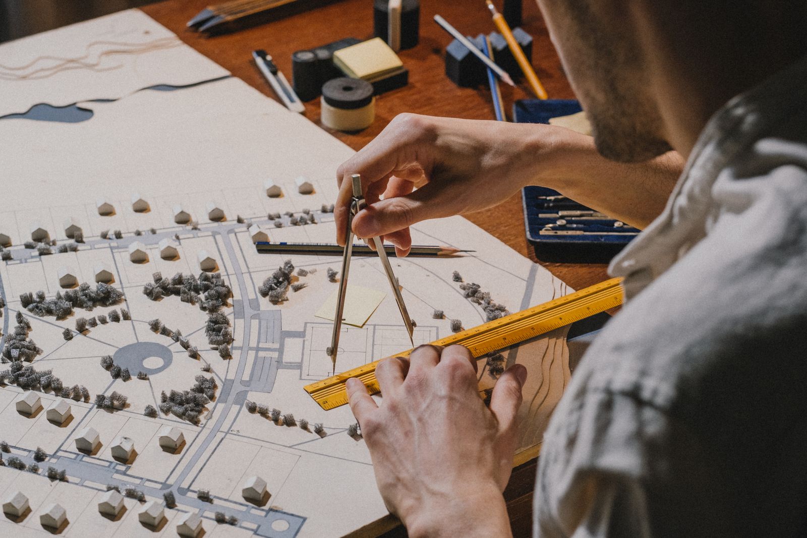 An architect working on a scale model of a site plan