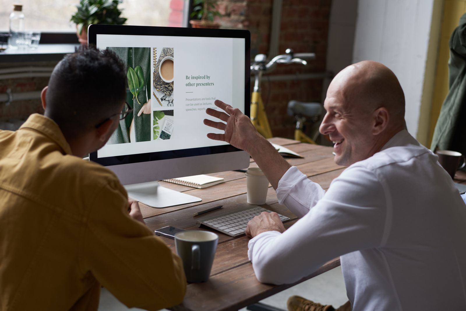 Two colleagues talking through the work on a shared screen
