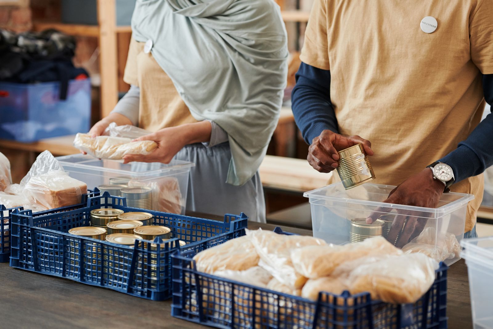 Volunteers packing food donations into crates